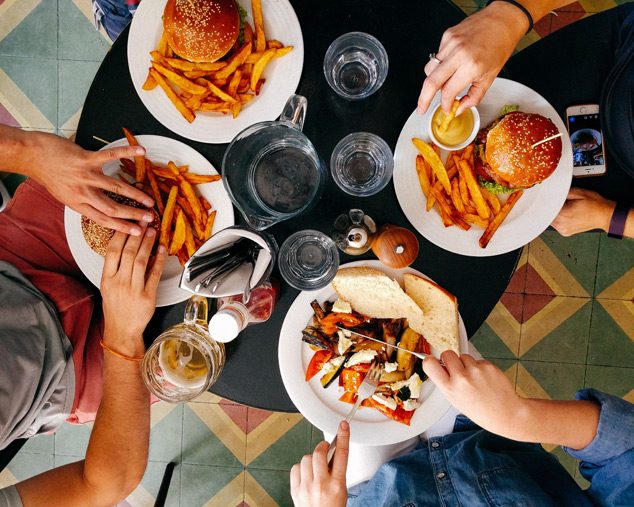 Burgers and fries shared around a table