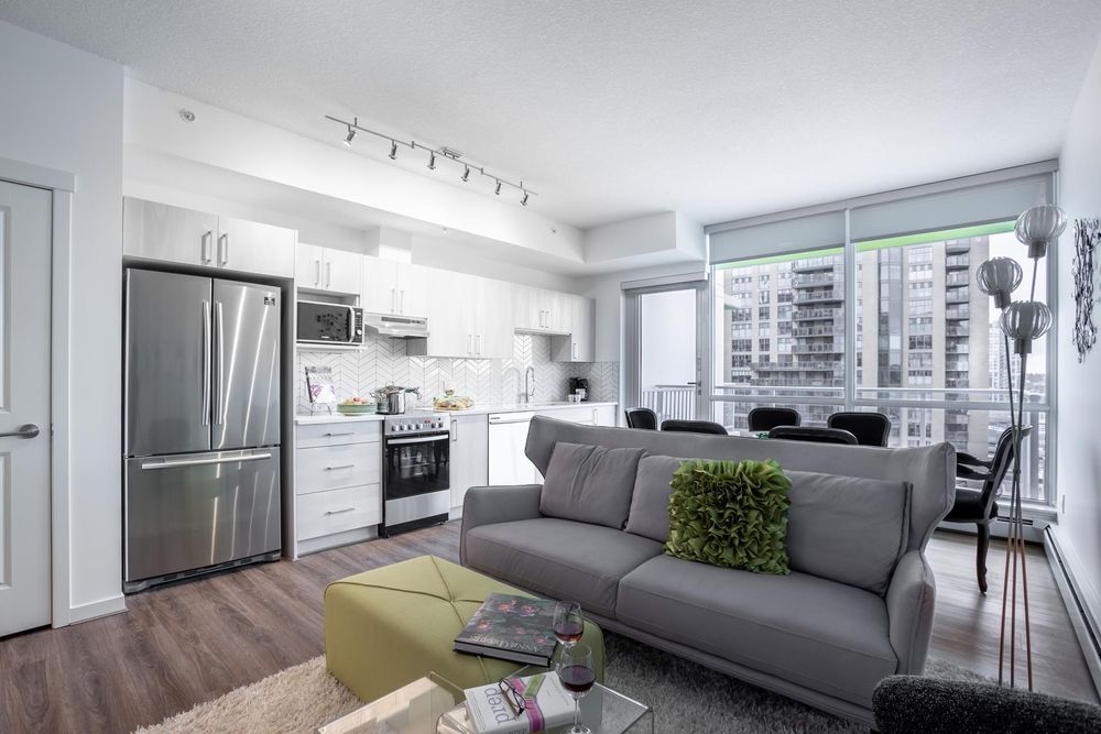 Open living room and kitchen with floor-to-ceiling windows